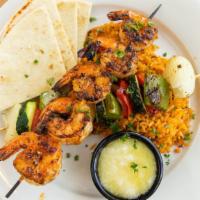Shrimp Souvlake · Greek style kebabs served with vegetables, saffron apricot rice pilaf with toasted almonds, ...