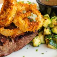 Top Sirloin · Porcini jus, spinach feta mashed potatoes, crispy fried onions, and grilled zucchini.