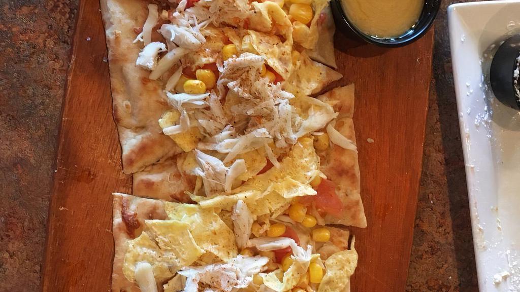Maryland Flatbread
 · Jumbo lump crab meat, tomatoes, corn, scrambled eggs on a crispy flatbread with mozzarella cheese, finished with old bay and a side of hollandaise.