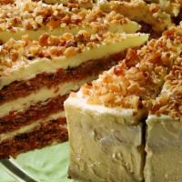 Carrot Cake · Alternating layers of carrot cake spiced with cinnamon, chopped walnuts and pineapple, cover...