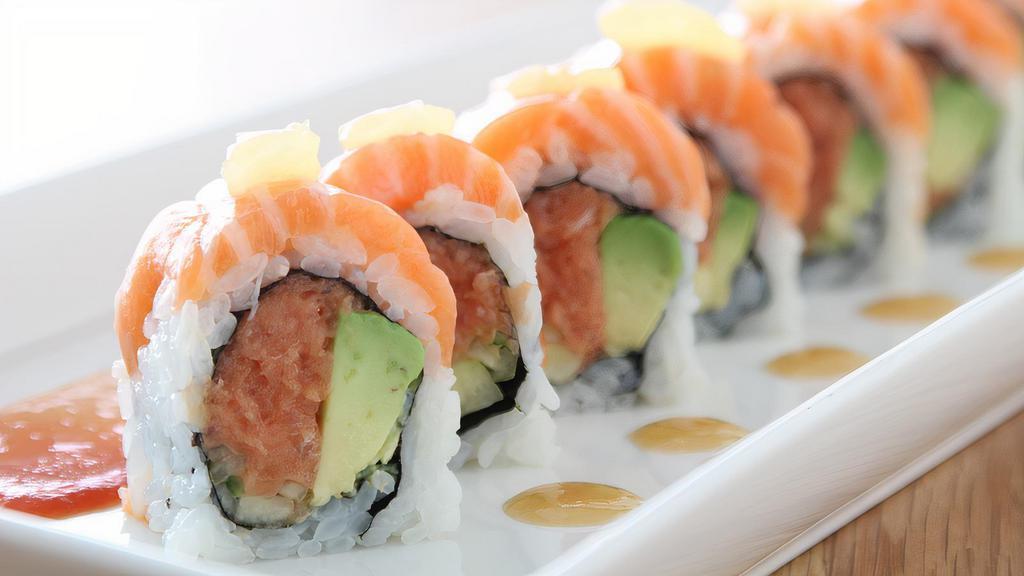 Tx Roll · spicy tuna, cucumber, avocado, topped with salmon, key lime, sweet miso, and spicy tomato sauce