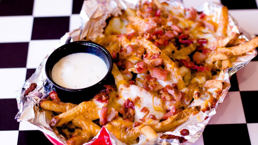 Loaded Fries · French fries topped with mozzarella, cheddar cheese, bacon bits and ranch dressing.