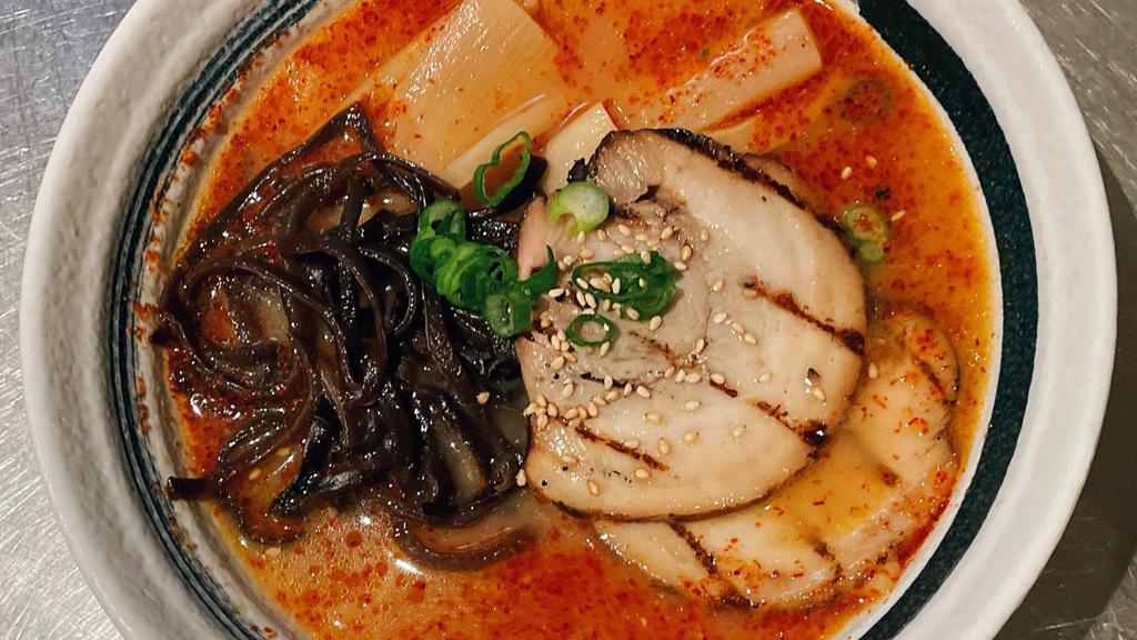 Spicy Miso Ramen · Tonkotsu (Pork) Broth with Miso Based Noodle Soup Topped with 2 Pieces of Chashu (Braised Pork), Green Onion, Dried Wood Ear Mushroom, Bamboo, Chili Powder