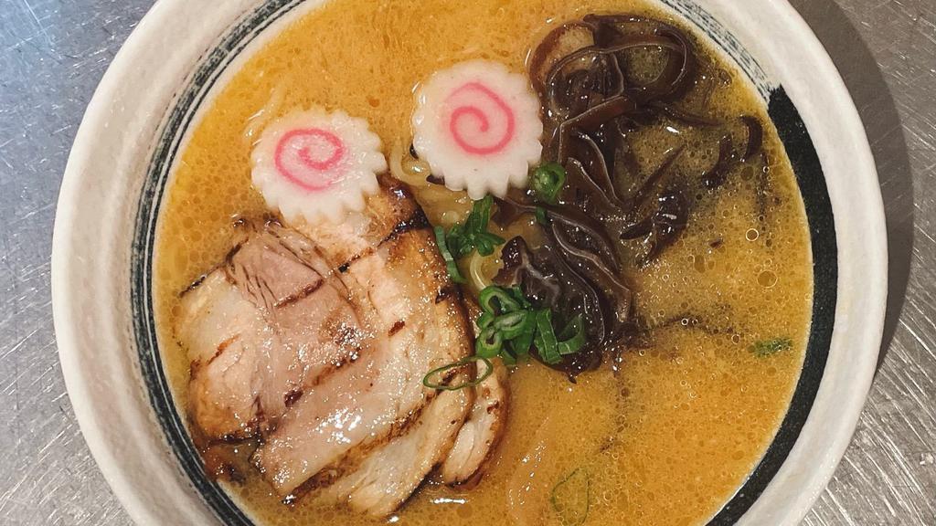 Miso Ramen · Tonkotsu (Pork) Broth with Miso Based Noodle Soup Topped with 2 Pieces of Chashu (Braised Pork), Green Onion, Dried Wood Ear Mushroom, Bamboo, Naruto