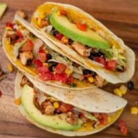 Cajun Chicken Tacos · Cajun grilled chicken, cheese blend, lettuce, black bean and corn salsa, topped with sliced ...
