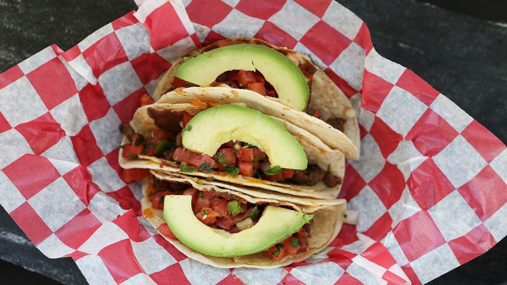 Seasoned Beef Tacos · Seasoned ground beef with cheese blend, pico de gallo, refried beans and sliced avocado