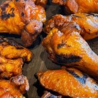 Chicken Wings · Generous plate of bone in wings tossed in a house made  Buffalo or BBQ sauce served with a s...