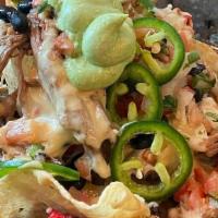 Smoked Brisket Nacho · In house smoked shredded brisket, cured with our special  rub, blended with queso, pico, bla...
