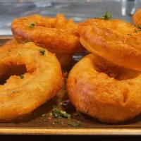 Beer Battered Onion Rings · Thick-cut onions dipped in house-made beer batter and served golden  brown. Comes with a sid...