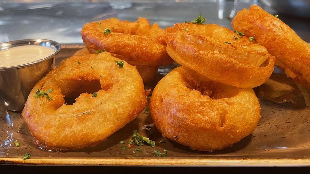 Beer Battered Onion Rings · Thick-cut onions dipped in house-made beer batter and served golden  brown. Comes with a side of our in-house jalapeno ranch