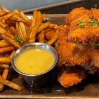 Fresh Breaded Crispy Chicken Strips W/ Rosemary Truffle Fries · Breaded in parmesan panko breading cooked to a  crispy crunchy golden brown. Served with han...