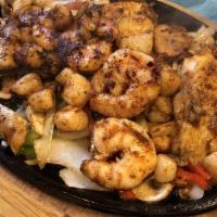 Seafood Fajitas · Prawns, scallops and white fish grilled with onion, red and green peppers and tomato, served...