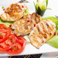 Grilled Chicken Breast (Pechuga De Pollo A La Parilla) · Juicy grilled chicken breast served with rice and  salad