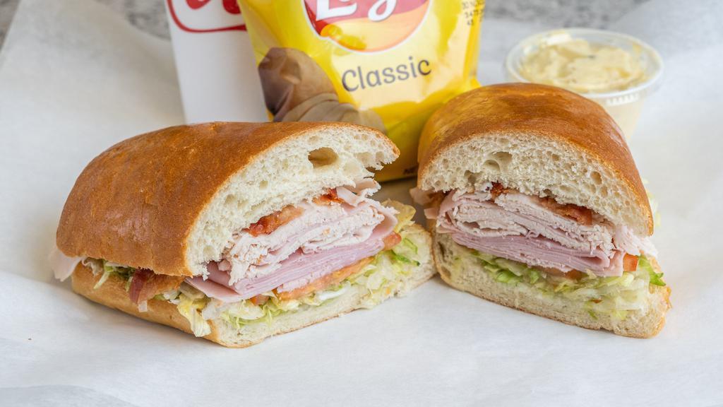 The Club Sandwich Meal · Turkey, ham, bacon, lettuce, tomato and mayonnaise on a subroll.