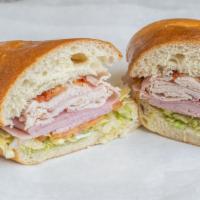 The Club Sandwich · Turkey, ham, bacon, lettuce, tomato and mayonnaise on a subroll.