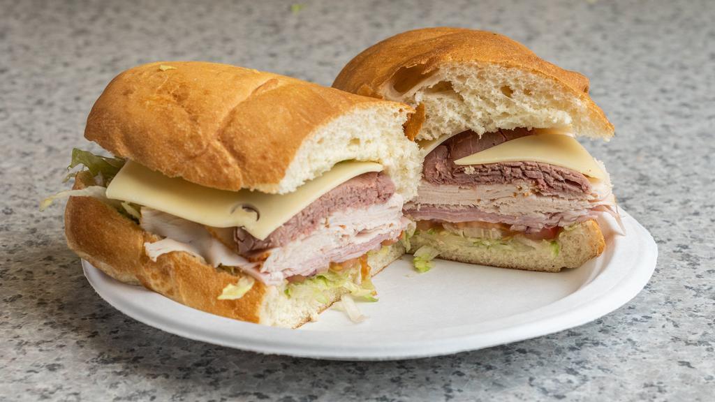 Deluxe Sandwich · Roast beef, ham, turkey, Swiss, lettuce, tomato, onions, mustard and mayonnaise on a subroll.