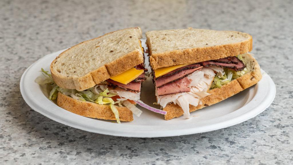 Double Play Sandwich · Turkey, pastrami, Cheddar, lettuce, tomato, onions, mustard and mayonnaise on rye.