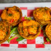 Mofonguitos · Fried plantain cups topped with your choice of meat, cheese, and drizzled with house-made sa...