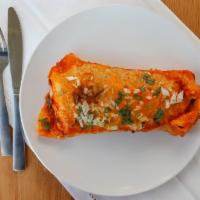 Burrito Chile Colorado · Beef burrito in red sauce with guacamole & sour cream, topped with melted cheese, onions, ci...