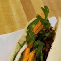 Grilled Meat Banh Mi · French baguette, cilantro, cucumber, jalapeño, pickled daikon/carrot, and spicy mayo. Protei...