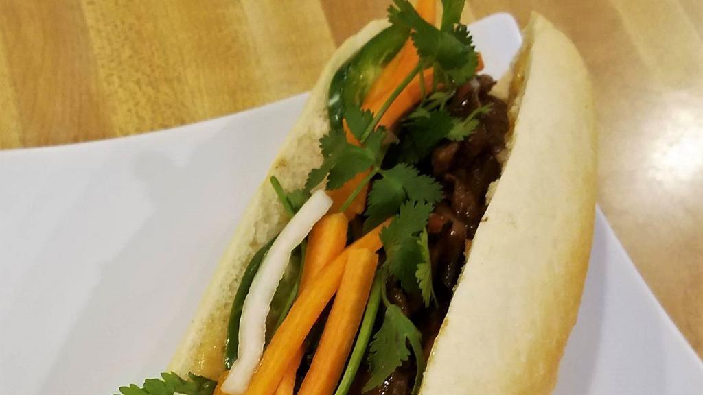 Lemongrass Banh Mi · French baguette, cilantro, cucumber, jalapeño, pickled daikon/carrot, and spicy mayo. Meat is stir fried with white onion, garlic, lemongrass, red chili paste (sweet, tangy, savory & spicy!)