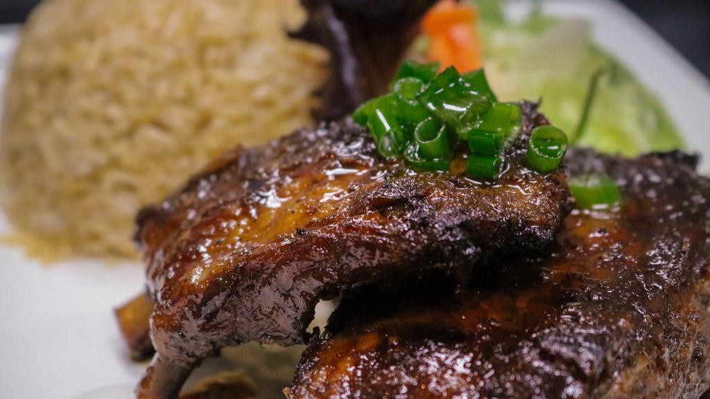 Grilled Pork Spare Ribs · Marinated and char-coaled grilled. Served with jasmine rice and mixed salad.