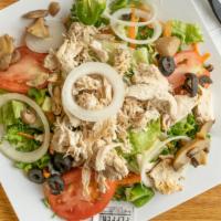 Grilled Chicken Salad · Crisp greens topped with grilled chicken with American and Jack cheese, tomatoes, served wit...