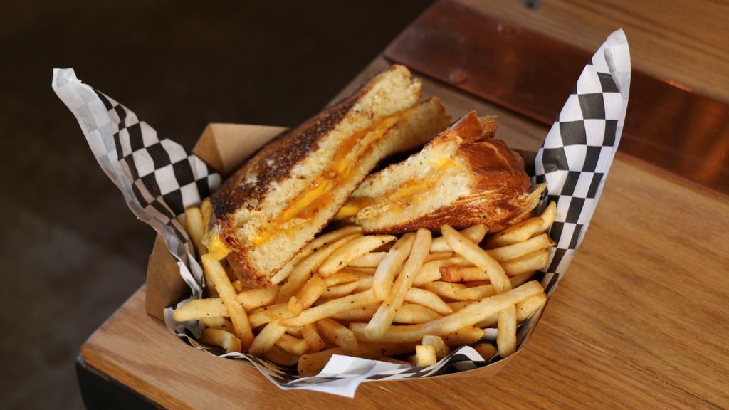 Grilled Cheese  · Cheddar, American, and Jack cheese served on toasted sourdough. Served with fries, or substitute fries for a salad.
