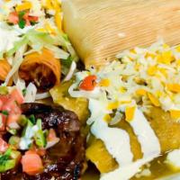 Tampiqueña · Two enchiladas, tacos dorados, tamal and marinated skirt steak.