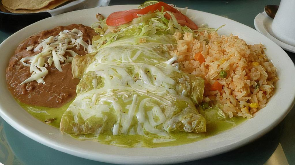 Enchiladas · Inside: meat of choice, four rolled corn tortilla topped with red or green sauce mozzarella cheese. Serve with rice & beans.