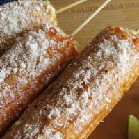 Elotes · Sweet corn slathered in a spicy mixture of mayonnaise, chili powder and then sprinkled with ...