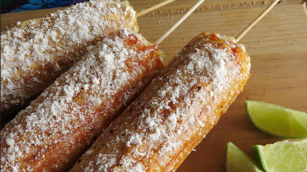 Elotes · Sweet corn slathered in a spicy mixture of mayonnaise, chili powder and then sprinkled with cheese.