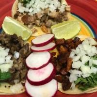 Taco · Los Tres Amigo Taqueria favorite: Meat of choice, onion and cilantro.