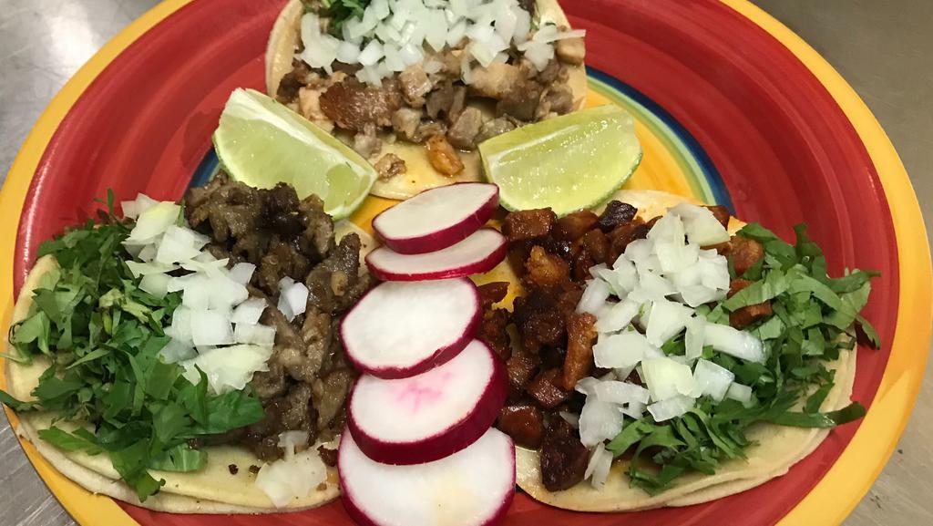 Taco · Los Tres Amigo Taqueria favorite: Meat of choice, onion and cilantro.