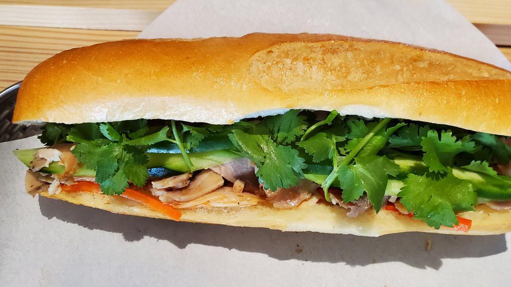 Grilled Chicken Banh Mi · Grilled lemongrass chicken, house mayo, pickled carrots, cucumber, jalapeño pepper, and cilantro.