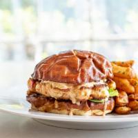 Shrimp Burger · On a pretzel bun with Thousand Island dressing and bread and butter pickles served with choi...