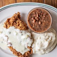 Chicken Fried Chicken · Topped with jalapeño cream gravy and served with mashed potatoes and black-eyed peas.