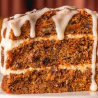 Carrot Cake Slice · Filled with raisins and pecans and layered with cream cheese icing.
