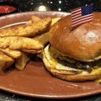Classic American Cheese Burger · American cheese with lettuce, tomato and pickles served on a brioche bun.