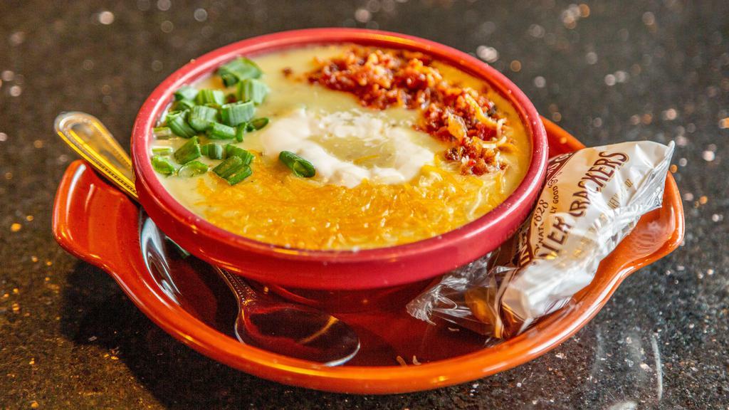 Loaded Baked Potato Soup · Creamy potato soup, topped with bacon, chives, Cheddar cheese and sour cream.