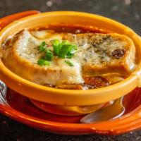 Vintage Onion Soup · Tender sweet onions in a hearty beef broth topped with house-made croutons and bubbling Swis...