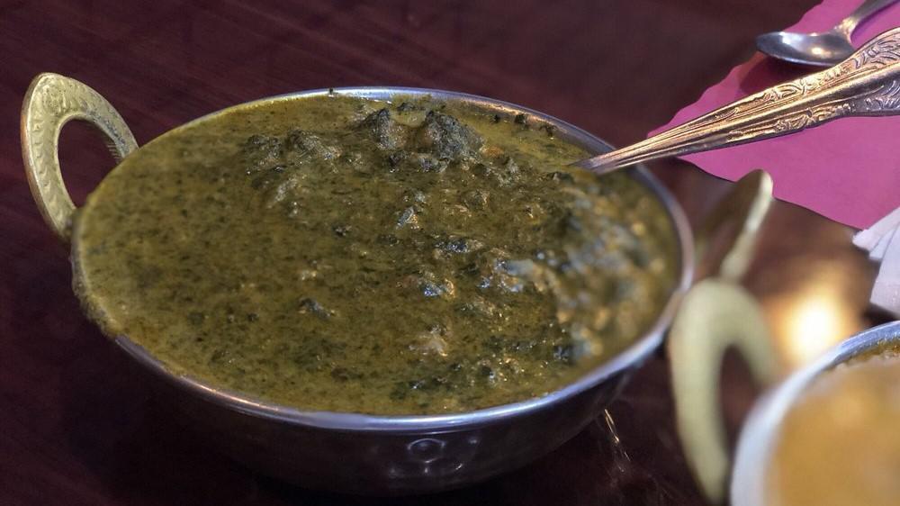 Palak Paneer · Paneer saag. Spinach and cottage cheese cooked with tomatoes, onions, and Indian spices.