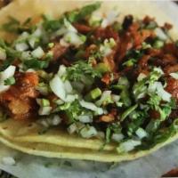Pastor Tacos · Three marinated pork tacos over corn tortilla.Served with a side of black beans, cilantro/on...