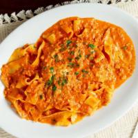 Pappardelle Bolognese · Wide noodles tossed with ground veal and bacon in rose sauce.