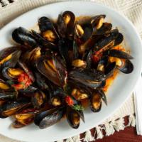Mussels Marinara · Fresh mussels in marinara sauce over linguini.