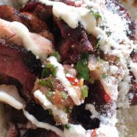 Brisket Taco Plate · comes with two brisket tacos on homemade flour tortillas and a side of beans.