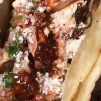 Smoked Chicken Taco-Single · comes on our homemade flour tortillas with smoked salsa rojo,crema,and cotija.