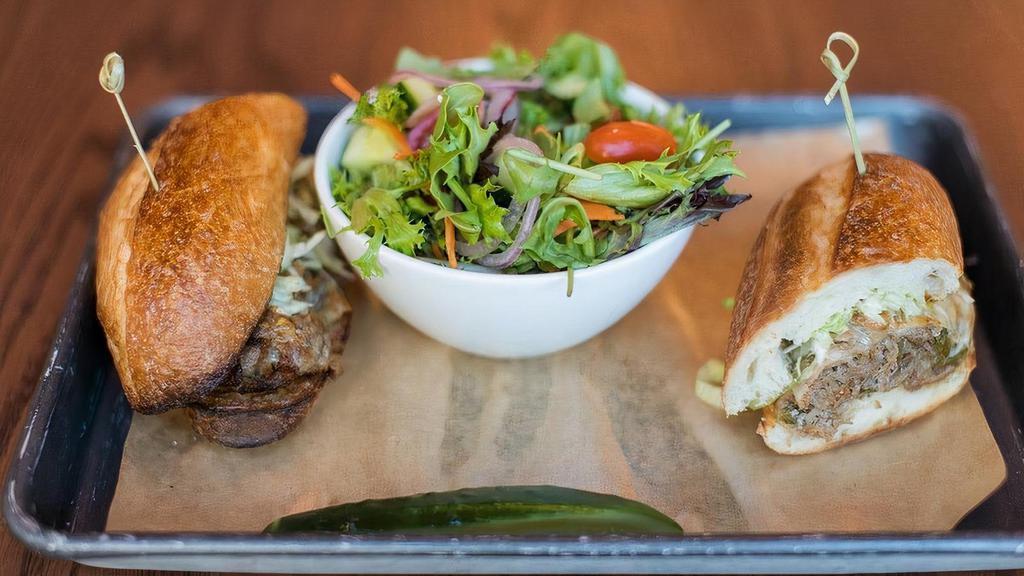 Shaved Steak Sandwich · caramelized onions, green peppers, cheddar, shaved lettuce, horseradish aioli, french roll