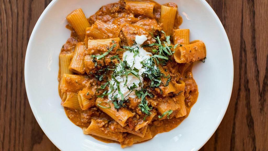 Rigatoni · House made sausage, pink sauce, fresh herbs and ricotta dollop