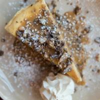 Almond & Toffee Cheesecake · almond and graham cracker crust, caramelized chocolate toffee crumble, dulce de leche, sea s...